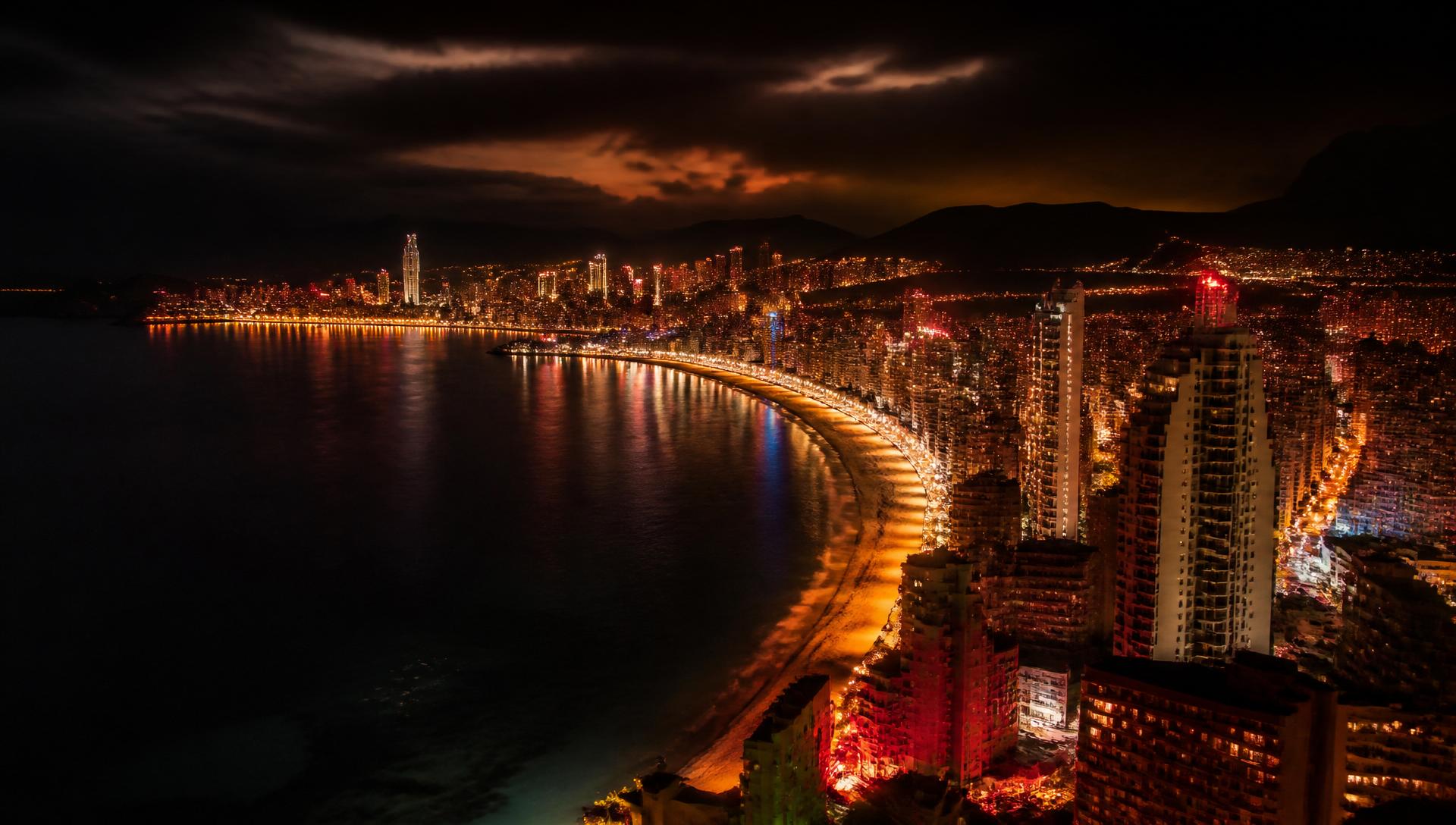 Benidorm skyline at night with glowing city lights along the coast
